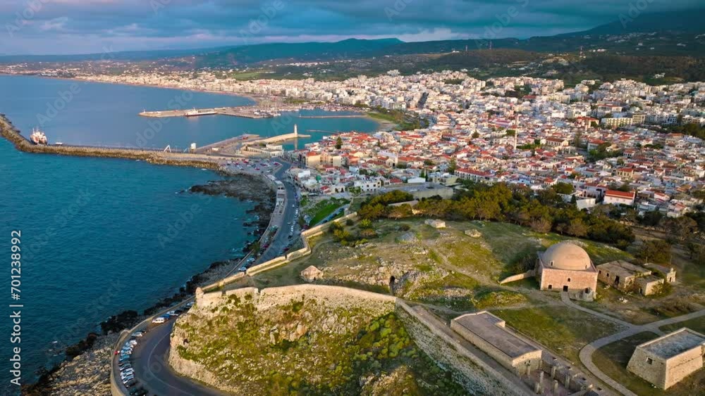 Aerial view of Venetian Fortezza Castle with luxury villas typically Greek whitewashed exterior in Crete. View from above of fortress ruins citadel offering panoramic views of Rethymno town and port. Aerial view of Venetian Fortezza Castle with luxury villas typically Greek whitewashed exterior in Crete. View from above of fortress ruins citadel offering panoramic views of Rethymno town and port.