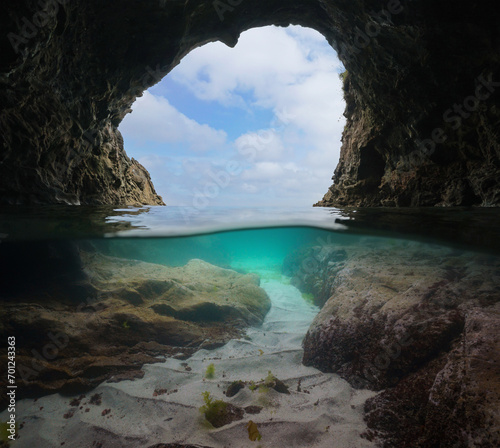 Inside a sea cave on the Atlantic coast of Spain, split view half over and under water surface, natural scene, Galicia, Rias Baixas