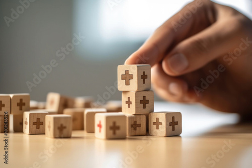 Close up of Hand arranging wood block with healthcare medical icon. Health insurance concept.