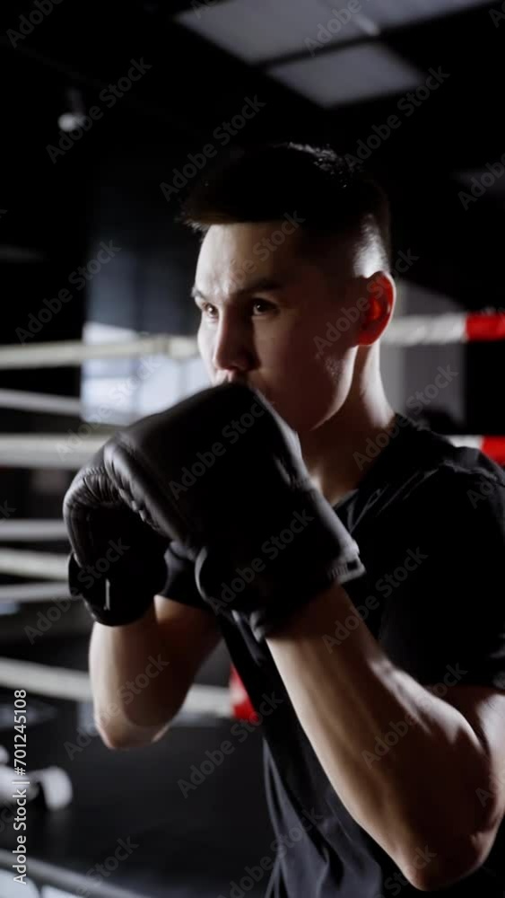 A confident athlete trains for a boxing match. Vertical video for smartphones. A confident athlete trains for a boxing match. Vertical video for smartphones.