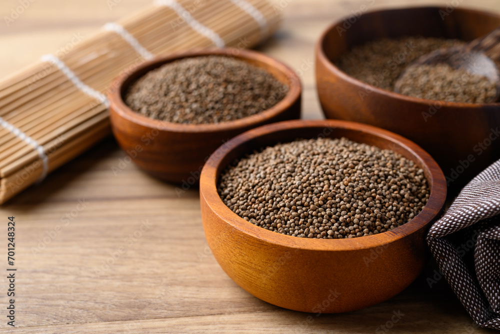 Perilla seed in wooden bowl, Healthy herbal seed ingredients in Asian food Perilla seed in wooden bowl, Healthy herbal seed ingredients in Asian food