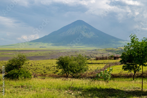 Scenic view of Mount Ol Doinyo Lengai against blue sky at Ngorongoro Conservation area in Tanzania