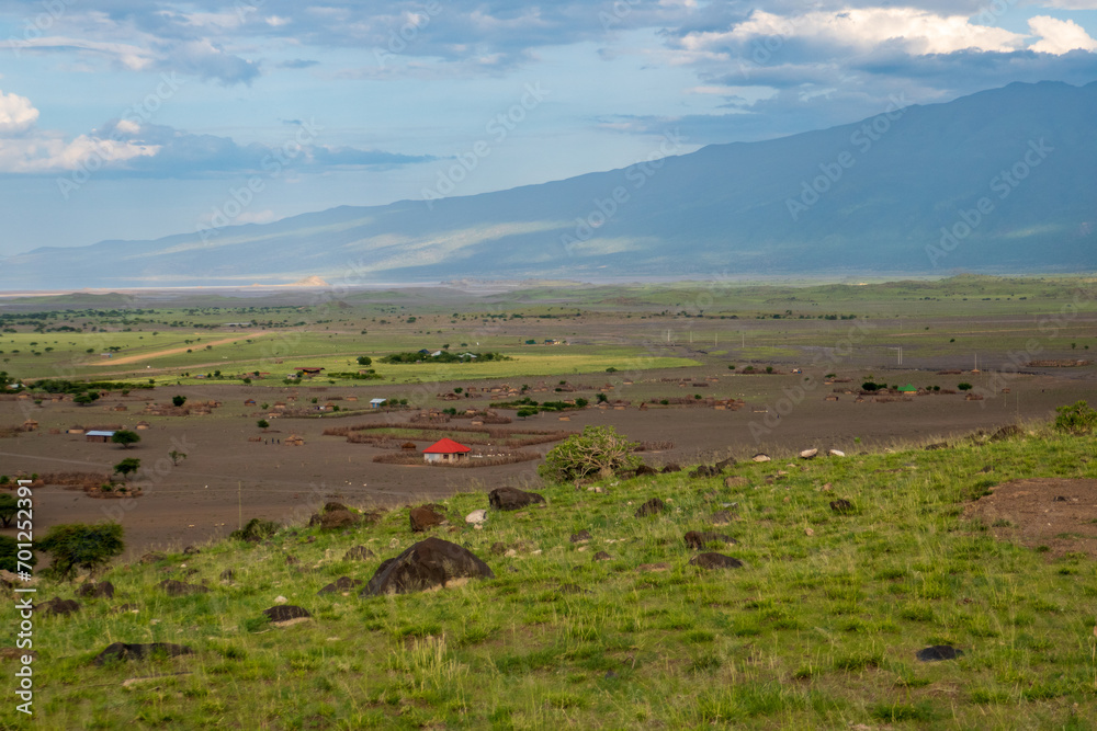 Obraz premium View of masai villages at the foothills of Mount Ol Doinyo Lengai in Tanzania