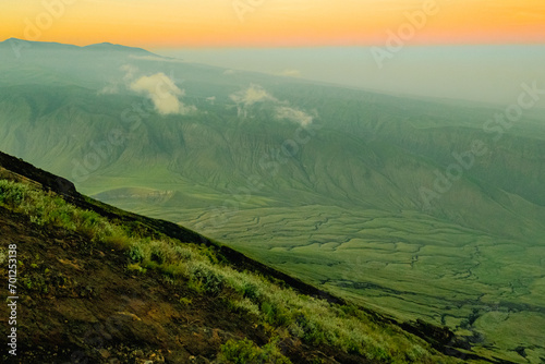 Scenic view of rock formations at Rift Valley at sunrise seen from Mount Ol Doinyo Lengai in Ngorongoro, Tanzania