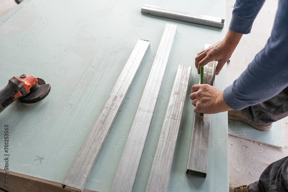 Workers fitting panel into frame of ceiling. Workers fitting panel into frame of ceiling.