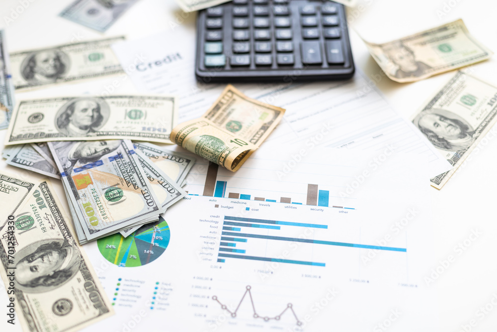 Accounting charts and graphs with us dollar bills pen calculator. Stock market graphs Accounting charts and graphs with us dollar bills pen calculator. Stock market graphs