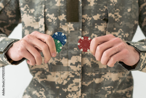 military man holding poker chips.