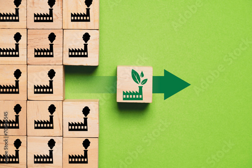 Green factory icon move out from black manufacturing icon for environmental friendly process and conservation to reduce and prevent industrial pollution concept photo