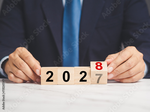 Flipping of 2027 to 2028 on wooden cubes for preparation of new year change