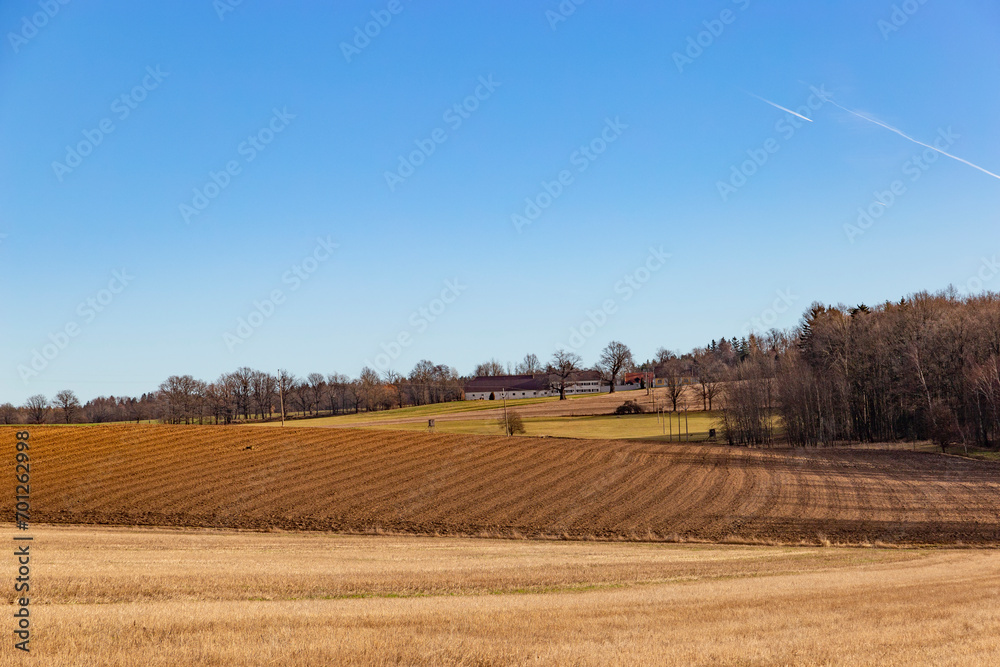 South Bohemian lands with farm, fields and forests. Early springtime. Czech Republic.