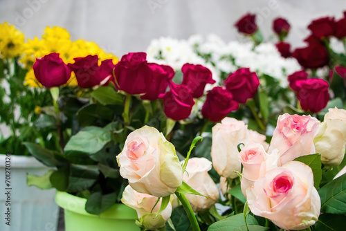 Bouquets of roses in flower shop. Selling fresh flowers for Valentines Day. Multi-colored flowers close-up.