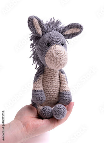 Handmade crochet donkey toy, amigurumi, isolated. © O.B.