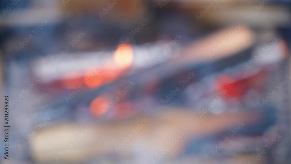 Blurred background of a burning calm fire. Burning firewood in the background with smoke. Relaxing atmosphere on the weekend Blurred background of a burning calm fire. Burning firewood in the background with smoke. Relaxing atmosphere on the weekend