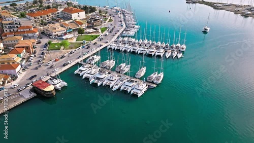 Aerial view of D-Marin Lefkas Marina full of boats and ships in Lefkada. The island's capital and port town with turquoise waters, Greek-style houses with colourful shutters, and wooden balconies. photo