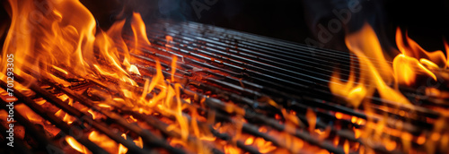 Empty flaming grill grates with open fire, ready for product placement. Background for grilled food with fire. photo
