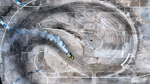Aerial view professional driver drifting car on race track, Race drift car with lots of smoke from burning tires on speed track, Car with smoke on wheels, Drifting car slow motion. photo