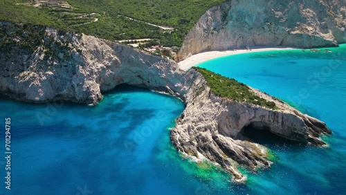 Porto Katsiki beach with turquoise water bordered by concave pale cliffs. Aerial view of crystal clear blue waters with picturesque views on the Ionian island of Lefkada, Greece. photo