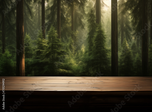 Empty wooden table with rays of light in the forest blurred background layout