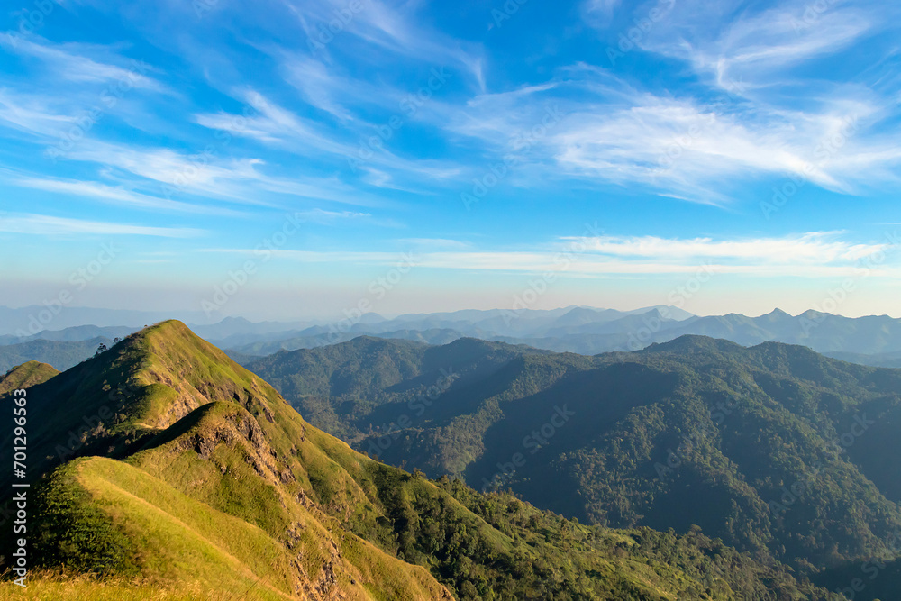 Naklejka premium Green yellow mountains and beautiful sky clouds under the blue sky.
