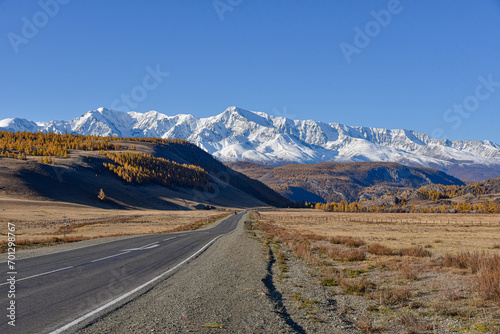 Mountain landscape. Road leading to mountain peaks in autumn.