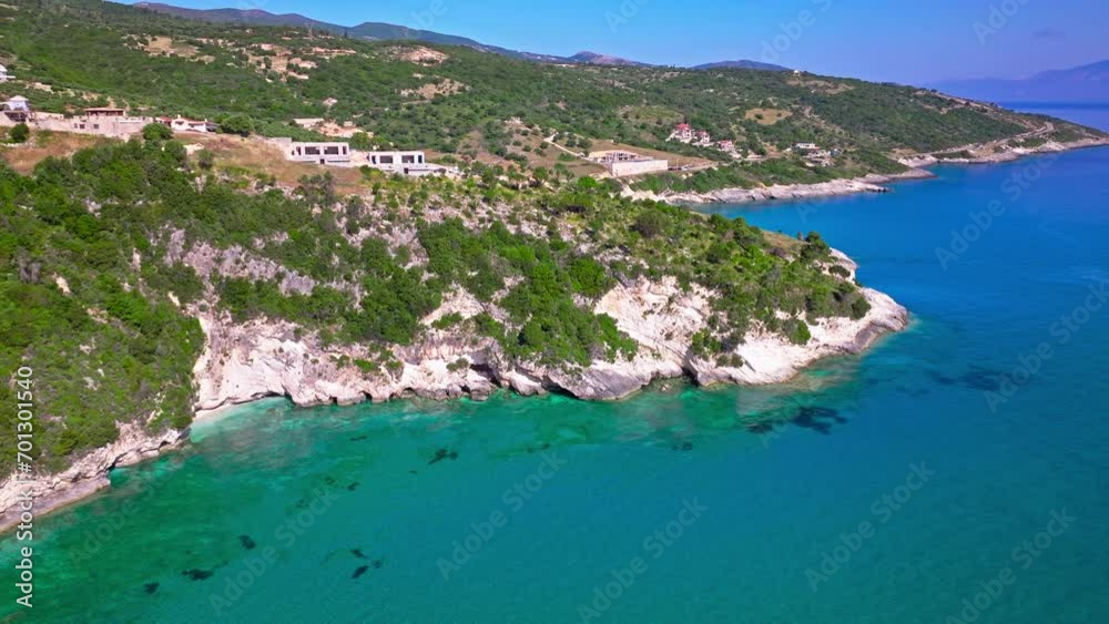Aerial view of tourist resort by the cliffs with turquoise waters in Greece. Tourists enjoy vacation at the hotel in Zakynthos by the beach with crystal clear blue water on the Greek Islands. Aerial view of tourist resort by the cliffs with turquoise waters in Greece. Tourists enjoy vacation at the hotel in Zakynthos by the beach with crystal clear blue water on the Greek Islands.