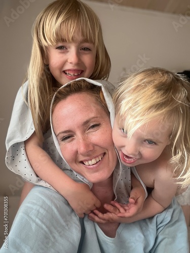 happy mother and two daughters laugh, take selfies, spend time together. High quality photo