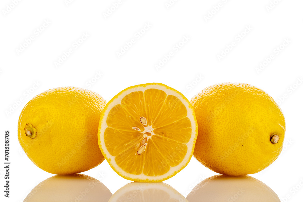 One half and two whole yellow juicy lemons, close-up, isolated on white. One half and two whole yellow juicy lemons, close-up, isolated on white.