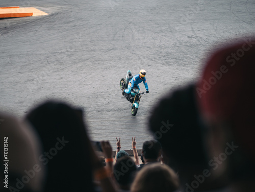 In this image, gestures of joy and awe intertwine as each person shares the thrill of witnessing an unforgettable motorized spectacle photo