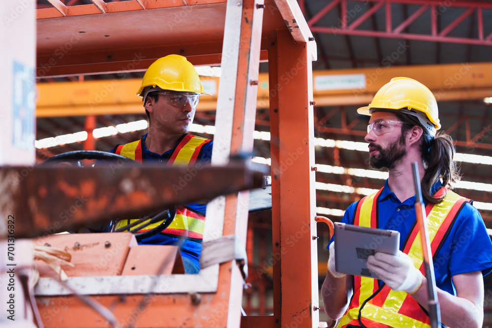 Teamwork working driver at warehouse forklift loader works to ...