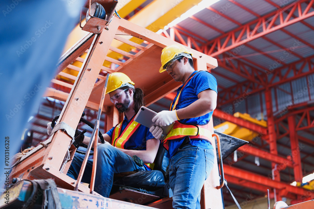 Teamwork working driver at warehouse forklift loader works to ...