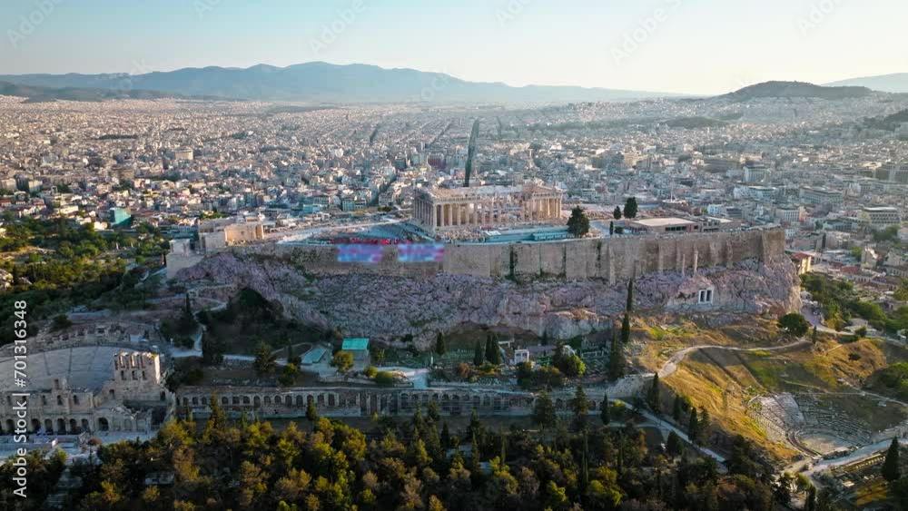 Aerial view of the ancient citadel Acropolis of Athens, historical landmark. Sunset over temple complex on rocky hilltop, landmark temple ruins on archaeological site of Parthenon and Amphitheater. Aerial view of the ancient citadel Acropolis of Athens, historical landmark. Sunset over temple complex on rocky hilltop, landmark temple ruins on archaeological site of Parthenon and Amphitheater.