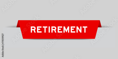 Red color inserted label with word retirement on gray background