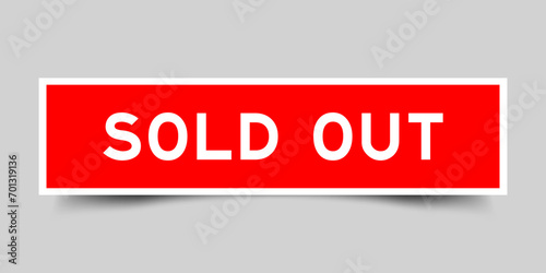 Square sticker label with word sold out in red color on gray background