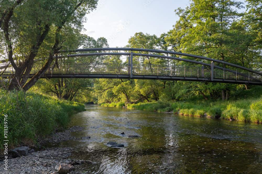 A small river from the bank, with a bridge A small river from the bank, with a bridge