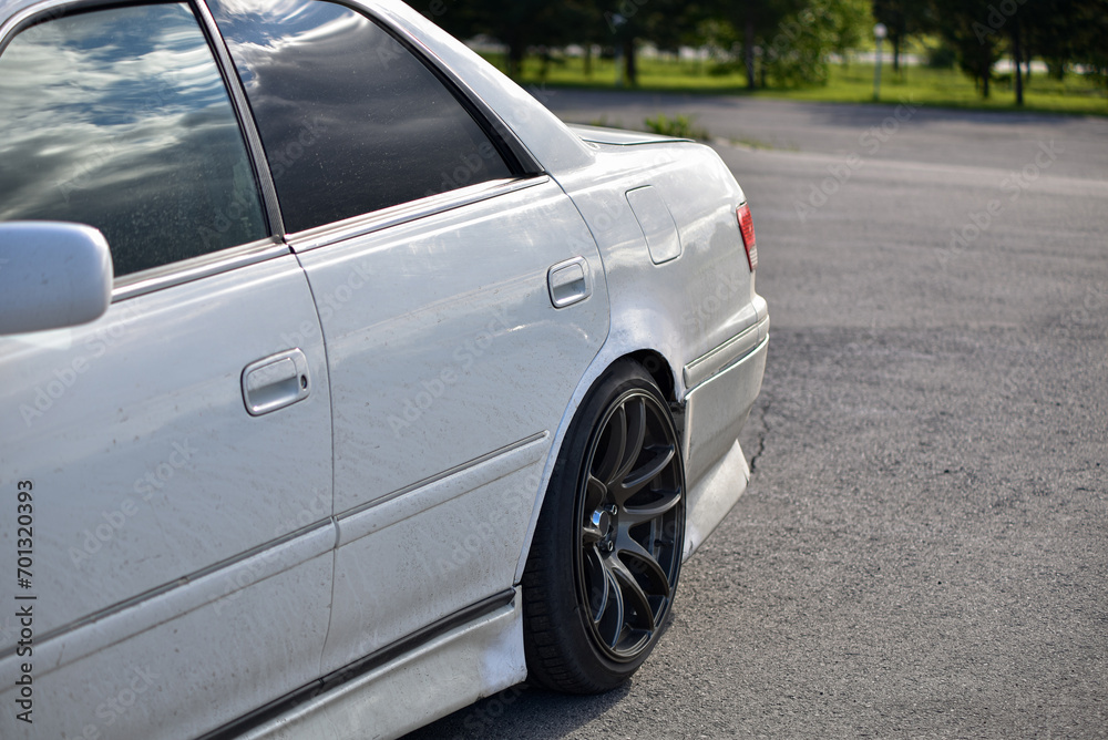 A white car is parked in the parking lot. side view. A white car is parked in the parking lot. side view.
