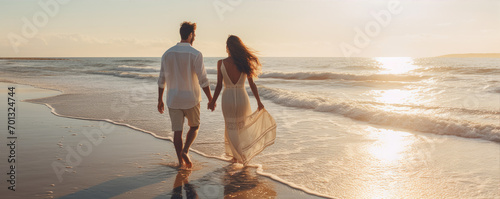 Happy young couple on the beach, enjoying their time together on the vacation. Active lifestyle concept photo