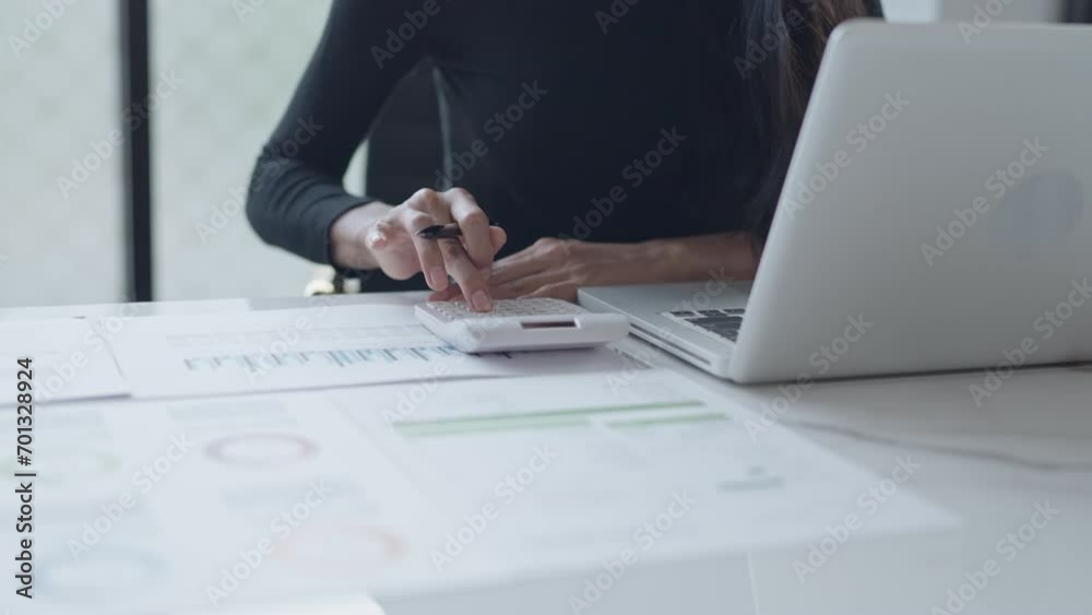 Business woman analyzing data paperwork calculating numbers Business woman analyzing data paperwork calculating numbers