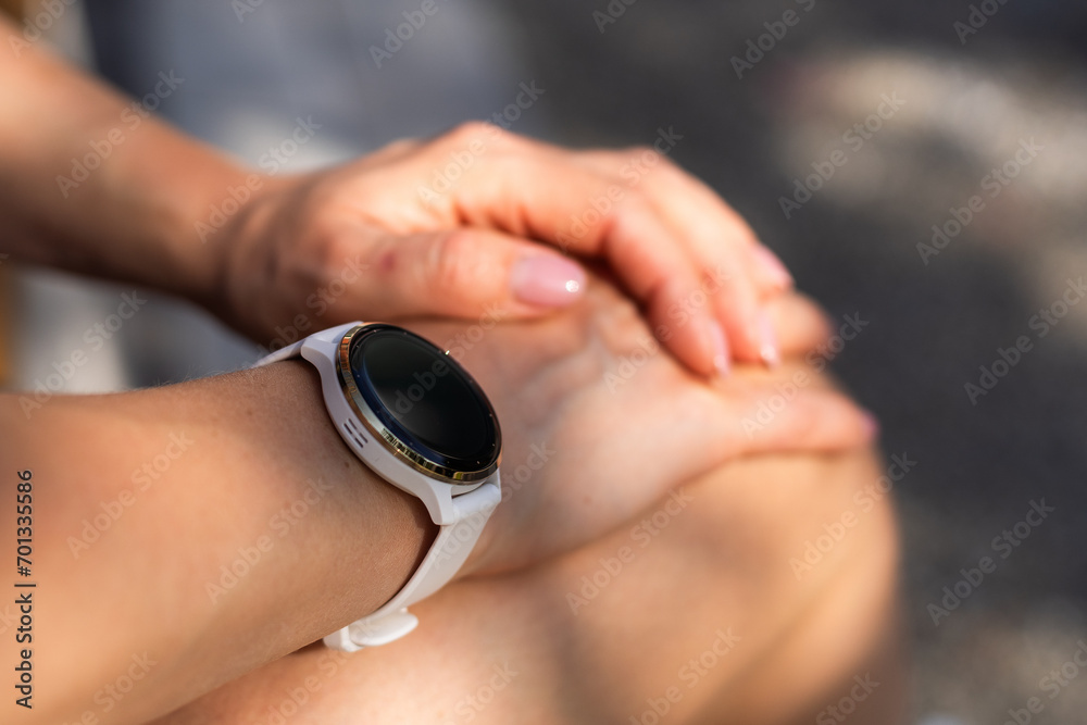 Fototapeta premium Modern sport gadget concept - young woman using a smartband