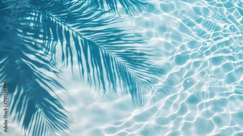 palm leaf shadow on blue water waves  vacation and beauty care with copy space