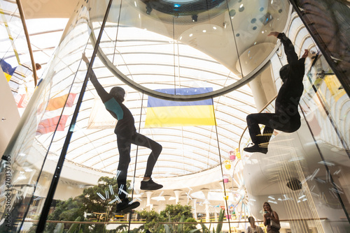 Indoor. Man fly in wind tunnel. Indoor skydiving. New fly sport. photo