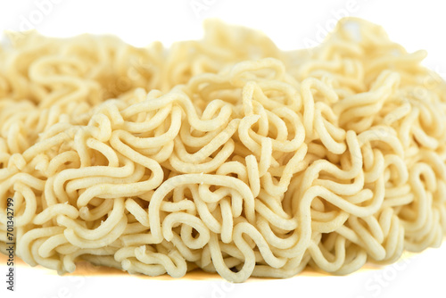 Close-up of dry instant noodles on a white background. Focus on the foreground  background blurred.