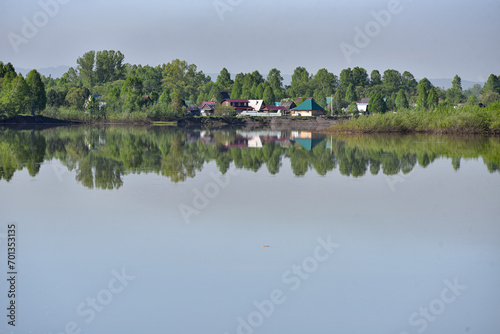 Village on the shore of a reservoir in summer.