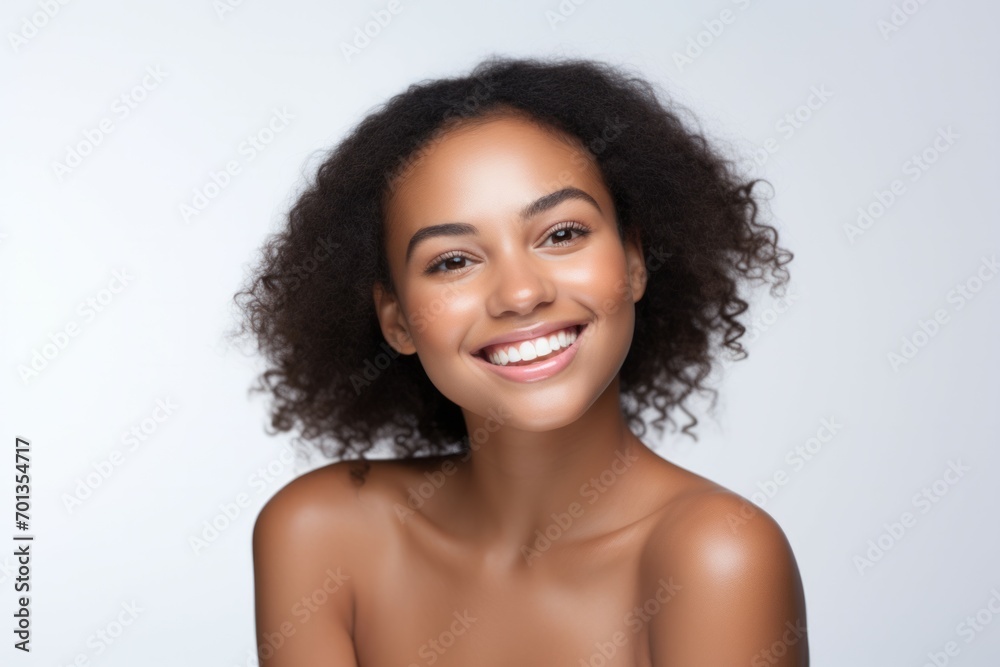 Beauty portrait of african american girl with clean healthy skin on beige background. Smiling dreamy beautiful black woman. Curly hair in afro style Beauty portrait of african american girl with clean healthy skin on beige background. Smiling dreamy beautiful black woman. Curly hair in afro style