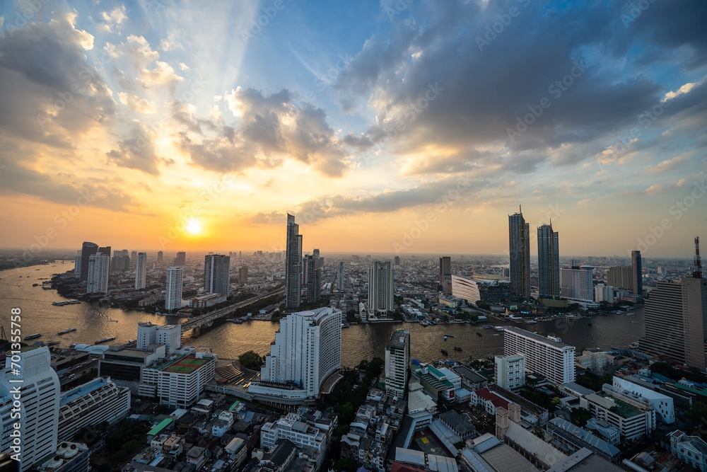 Sunset view of the Chao Phraya River with buildings and temples, Bangkok, the capital of Thailand and a tourist destination.