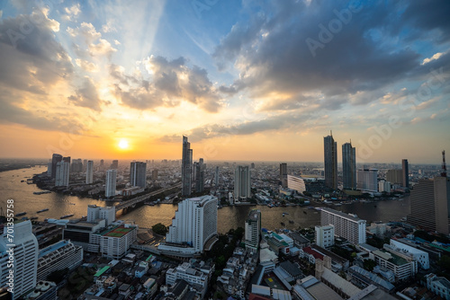 Sunset view of the Chao Phraya River with buildings and temples, Bangkok, the capital of Thailand and a tourist destination.