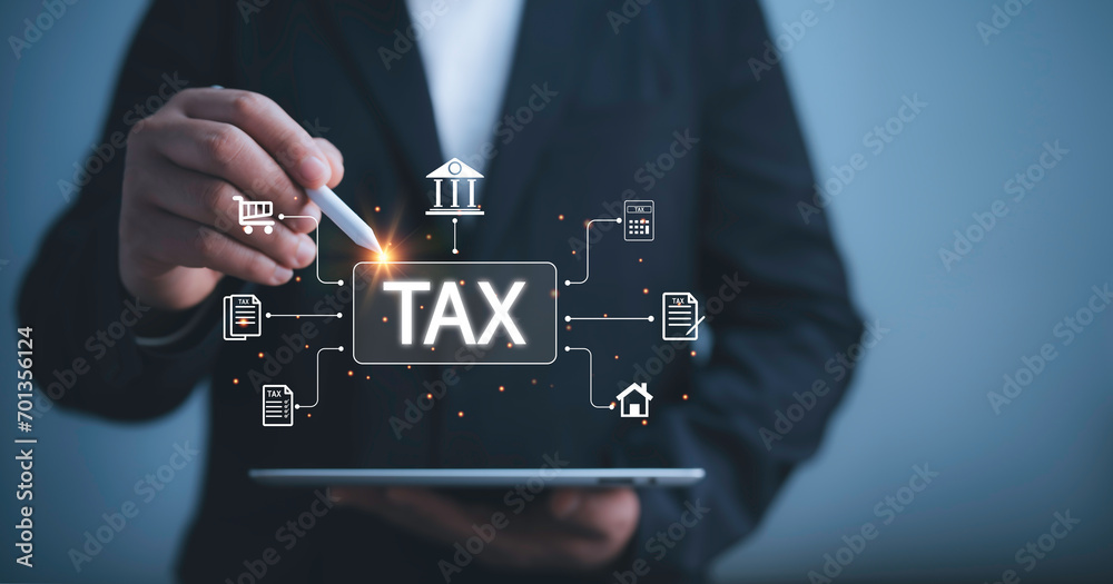 Businessman use tablet  to complete Individual income tax return form online for tax payment. Financial research,government taxes and calculation tax return concept. Tax and Vat concept. - obrazy, fototapety, plakaty 