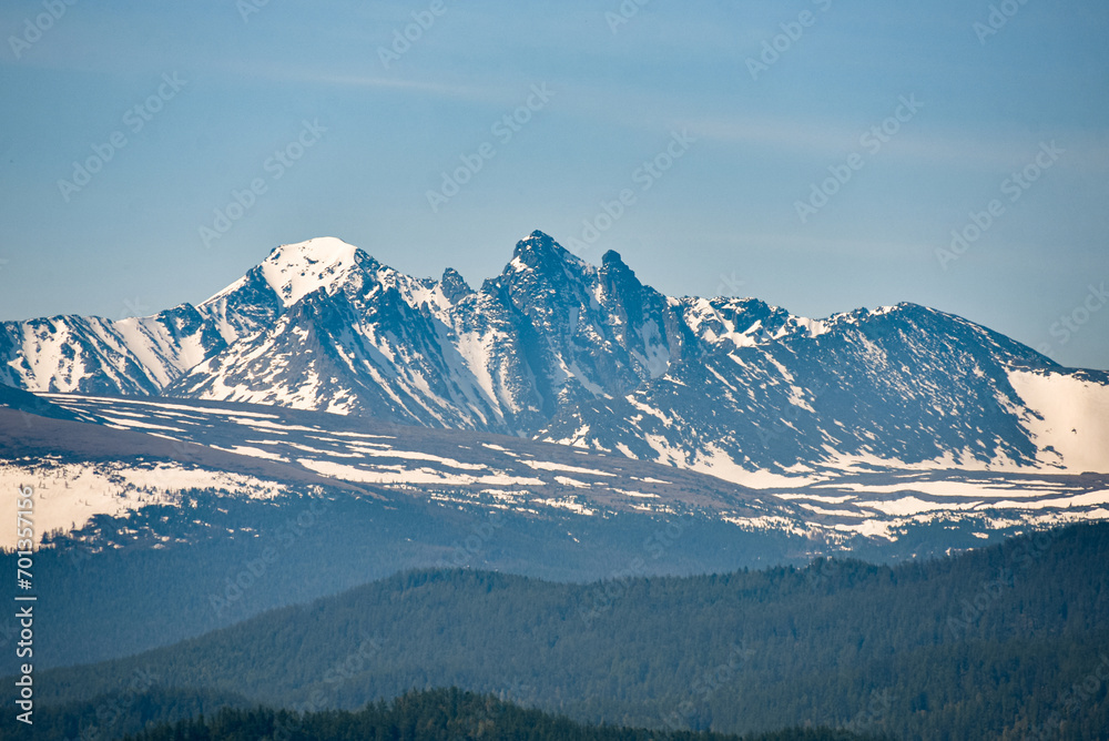 snowy peaks of mountains on a sunny day.