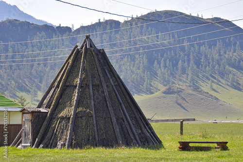 The yurt is made of wood, the roof of the yura is covered with tree bark. photo