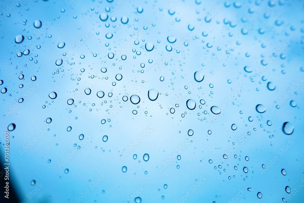 Close up rainwater drop on glass with blue sky background, wallpaper, bubbles, natural, water 
