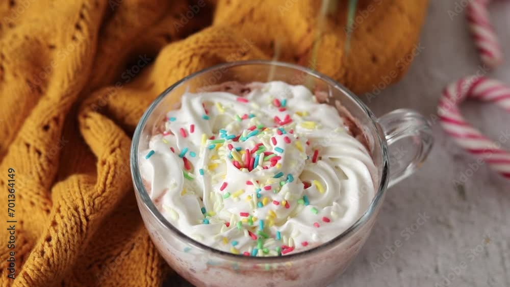 Rainbow sprinkles falling on a coffee cup with whipped cream topping. Colorful birthday party hot drink. Rainbow sprinkles falling on a coffee cup with whipped cream topping. Colorful birthday party hot drink.